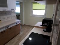 A kitchen or kitchenette at Csóka Apartman Pápa
