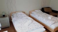 A bed or beds in a room at Csóka Apartman Pápa