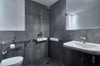 a bathroom with a sink and a toilet and a mirror at Palazzetto Rosso - Art Hotel in Siena