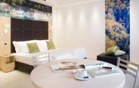 a hotel room with a bed and a table with a tableasonable at Domus Residence in Domodossola