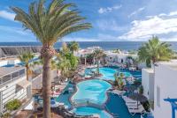 an aerial view of a resort with a pool and palm trees at Apartamentos Parque Tropical en Lanzarote in Puerto del Carmen