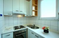 a white kitchen with a sink and a stove at Apartman Tramontana in Opatija