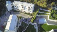 an overhead view of a large white building with a driveway at Apartman Tramontana in Opatija