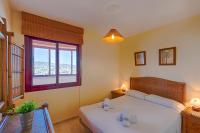 A bed or beds in a room at Villas Guzman - Apartamento Coral Beach