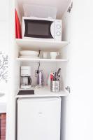 a kitchen with a white counter with a microwave at Forenom Aparthotel Lahti in Lahti