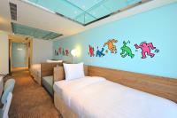 a bedroom with two beds and a large wall mural at Green World Hotel - Zhonghua in Taipei