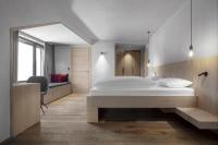 A bed or beds in a room at Hotel Krondlhof