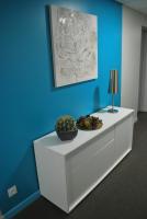 a white dresser in a room with a blue wall at Hotel Bleu Azur in Argelès-sur-Mer