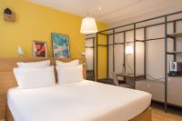 a bedroom with a white bed and a yellow wall at Maison Nô - Hôtel et Rooftop in Lyon