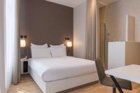 a bedroom with a white bed and a table at Maison Nô - Hôtel et Rooftop in Lyon