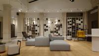 a living room with couches and chairs and a wall of photographs at Maison Nô - Hôtel et Rooftop in Lyon