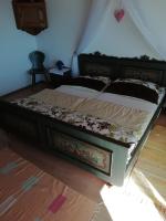 a bedroom with a large bed with a wooden floor at Haus Homann in Sulzberg