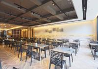 a restaurant with tables and chairs in a room at Royal Group Hotel Minghua Branch in Kaohsiung