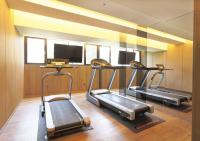 a gym with two treadmills and a television at Royal Group Hotel Minghua Branch in Kaohsiung