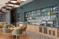 a restaurant with tables and chairs and a counter at Expo Hotel Sofia - Free Airport Shuttle in Sofia