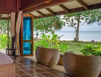 a room with chairs and a view of the ocean at Koh Jum Beach Villas "A member of Secret Retreats" in Ko Jum