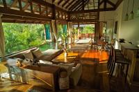 a living room with a couch and a table at Koh Jum Beach Villas "A member of Secret Retreats" in Ko Jum