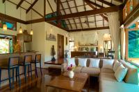 a living room with a couch and a table at Koh Jum Beach Villas "A member of Secret Retreats" in Ko Jum
