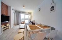 Televízia a/alebo spoločenská miestnosť v ubytovaní Apart-Invest Apartament Oslo