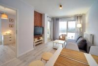Televízia a/alebo spoločenská miestnosť v ubytovaní Apart-Invest Apartament Oslo