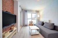 Televízia a/alebo spoločenská miestnosť v ubytovaní Apart-Invest Apartament Oslo