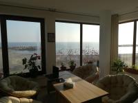 a living room with a table and chairs and windows at Vila pe plaja nr 9 in Saturn