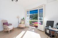 a living room with a desk and chairs and a television at Appartement Nice Port in Nice