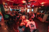 a group of people sitting at tables in a restaurant at Nomads St Kilda in Melbourne