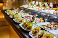 a buffet line with plates of food on display at Desert Rose Resort in Hurghada