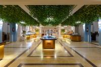 a lobby with a fountain in the middle of a building at Desert Rose Resort in Hurghada