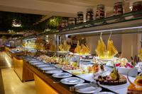 a buffet line with plates of food on display at Desert Rose Resort in Hurghada