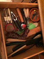 a drawer with cooking utensils in a wooden box at Les Galets in Tracy-sur-Mer