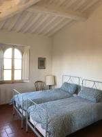 Posteľ alebo postele v izbe v ubytovaní villa montalcino palazzina castelverdelli
