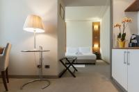 a bedroom with a bed and a table with a lamp at Hotel Barrage in Pinerolo