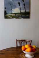 a bowl of fruit on a table with a painting at Veeve - Artistic in Pigalle in Paris