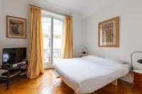 a bedroom with a large bed and a television at Veeve - Artistic in Pigalle in Paris