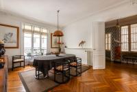 a living room with a black table and chairs at Veeve - Artistic in Pigalle in Paris