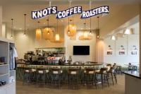 a restaurant with a bar with bar stools at Queen Kapiolani Hotel in Honolulu