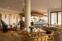 a restaurant with tables and chairs and a bar at Queen Kapiolani Hotel in Honolulu