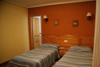 A bed or beds in a room at Hotel Garganta del Cares
