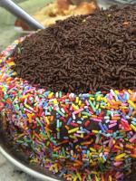 a chocolate cake with sprinkles on a plate at Hotel Olivier in Três Rios