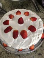a cake with strawberries on top of it on a plate at Hotel Olivier in Três Rios