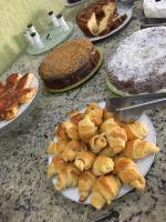 a table topped with plates of pastries and cakes at Hotel Olivier in Três Rios