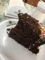 a piece of chocolate cake with sprinkles on a plate at Hotel Olivier in Três Rios