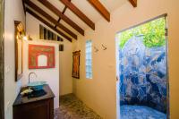 a bathroom with a sink and a large glass door at Koh Jum Beach Villas "A member of Secret Retreats" in Ko Jum