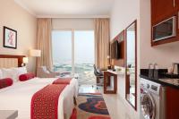 a hotel room with a bed and a large window at Treppan Hotel & Suites By Fakhruddin in Dubai