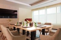 a dining room with a table and chairs at Treppan Hotel & Suites By Fakhruddin in Dubai