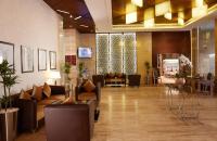 a lobby with couches and chairs in a building at Treppan Hotel & Suites By Fakhruddin in Dubai