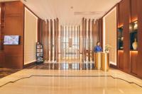 a woman standing in the middle of a lobby at LJZ Supreme Tower Hotel in Shanghai