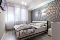 Łóżko lub łóżka w pokoju w obiekcie Apartamenty Granitica Zakopane